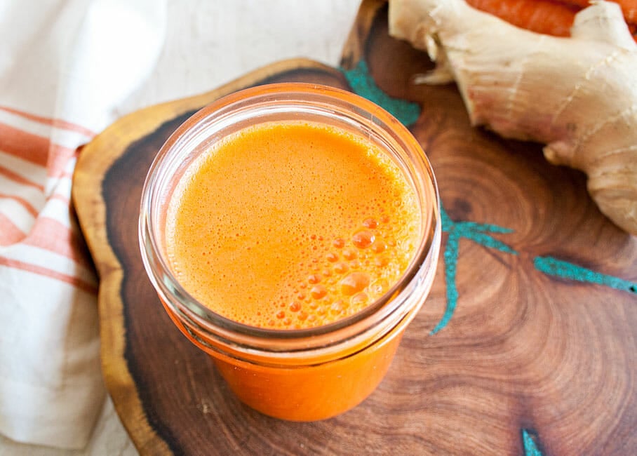 Carrot Ginger Juice on cutting board.