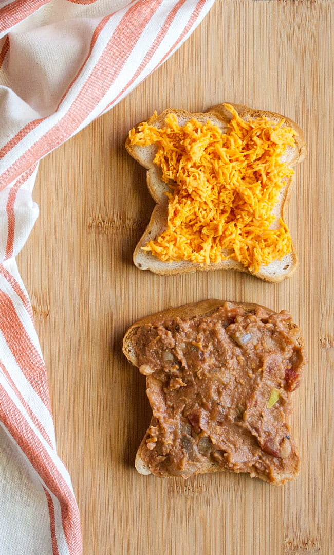 Open faced vegan sandwich on cutting board.