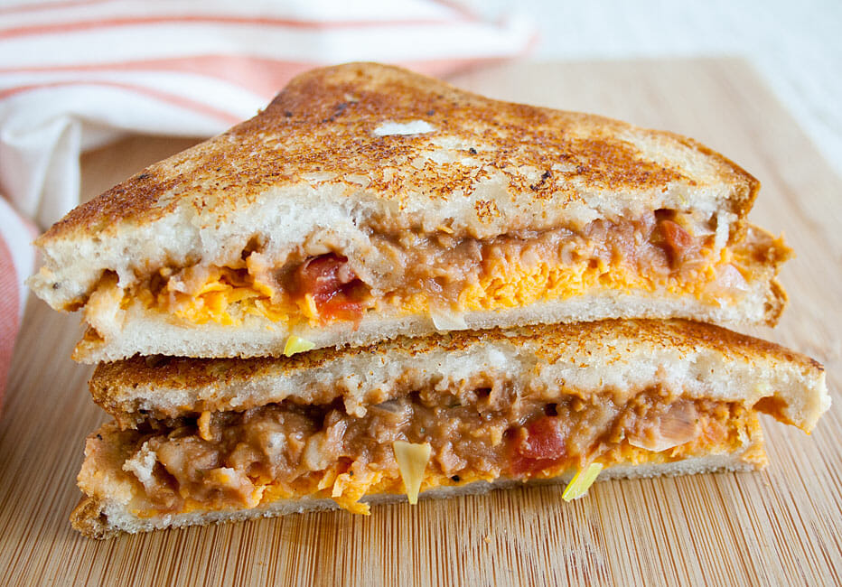 Refried Bean Grilled Cheese sliced in half and stacked.