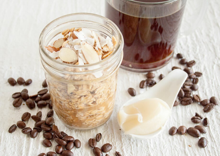 Thai Coffee Overnight Oats in a mason jar with a cup of coffee next to it.