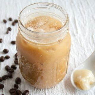 Cold Brew Thai Iced Coffee in a glass with a spoonful of sweetened condensed coconut milk.