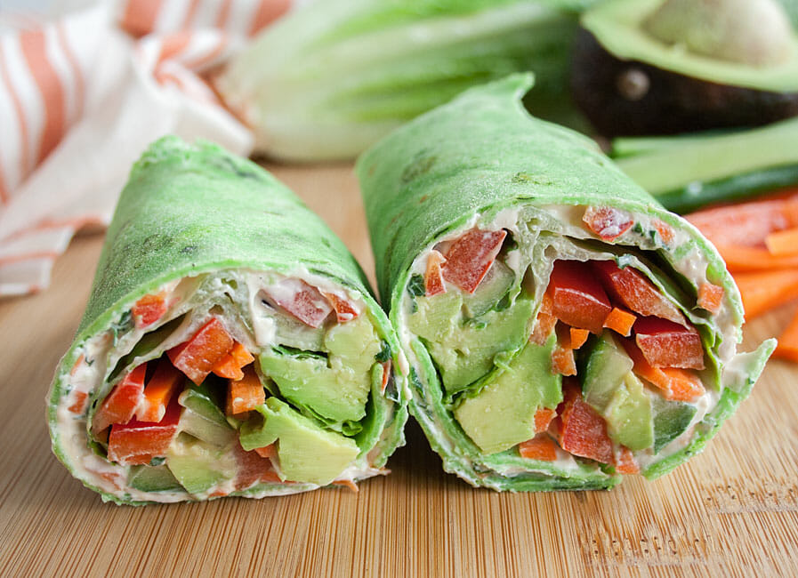 Vegan Wrap cut in half on a cutting board.