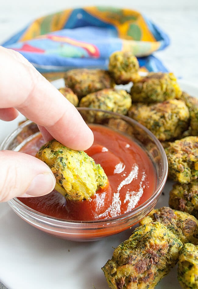 Broccoli Tot being dipped in ketchup.