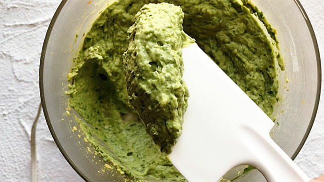 Avocado basil pesto in a food processor after mixing.