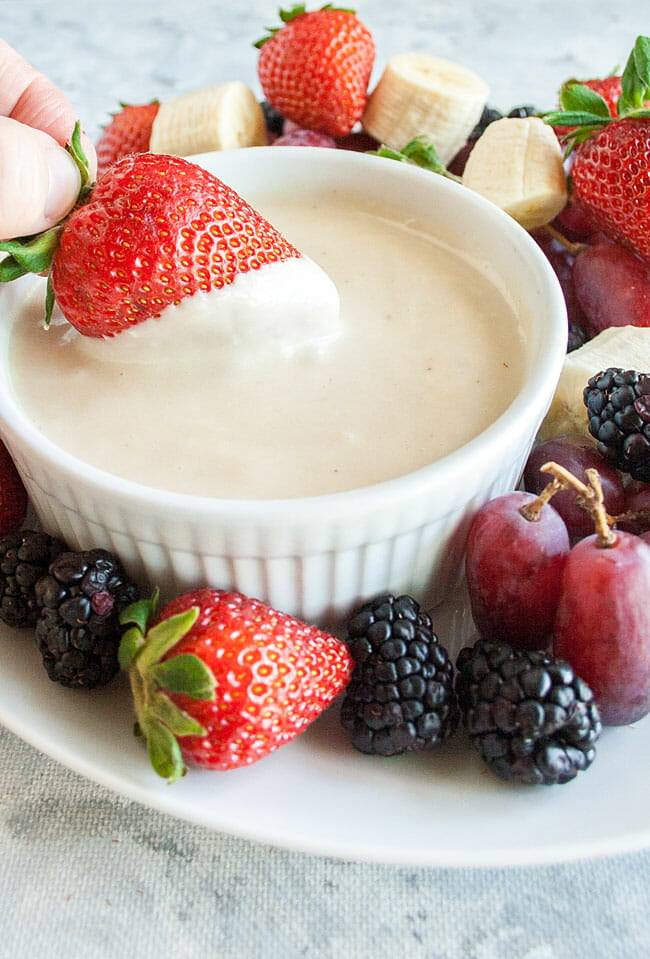 Vegan Fruit Dip with strawberry being dunked.