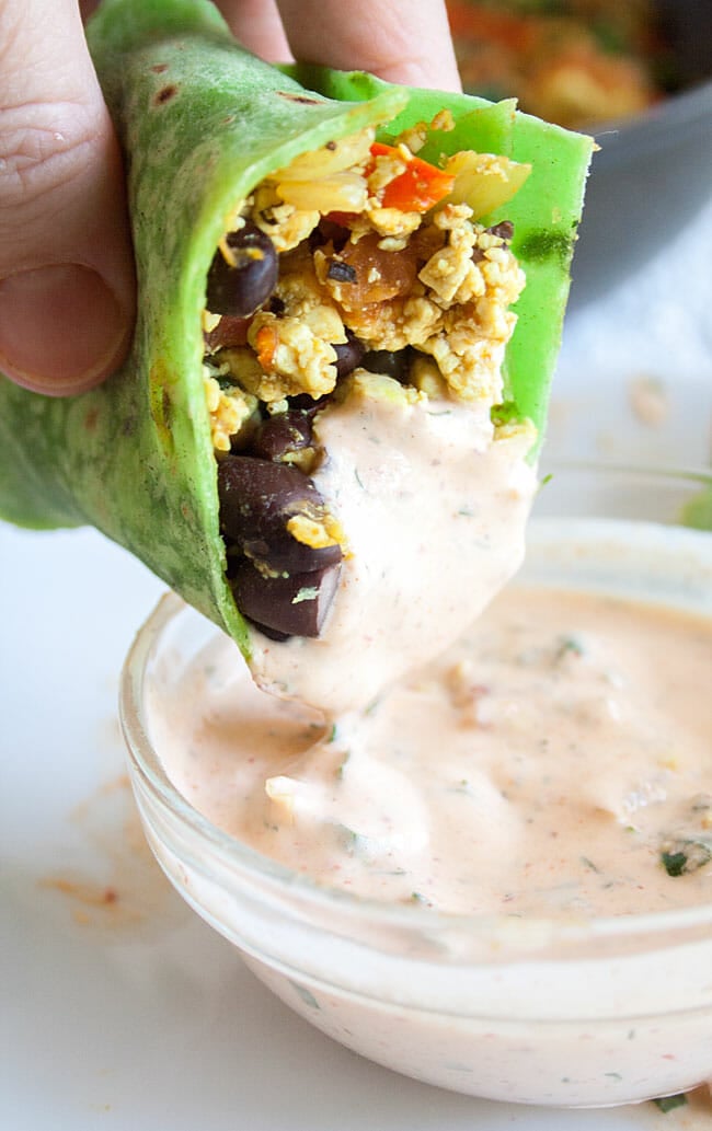 Burrito being dipped in Buffalo Ranch Dressing.