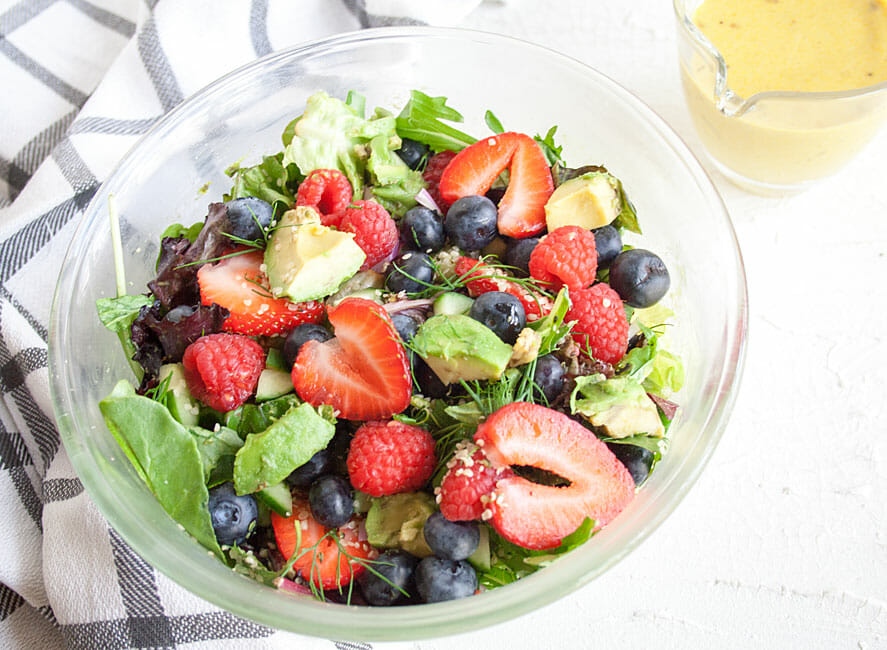 Avocado and Berry Salad with Turmeric Tahini Dressing close up.