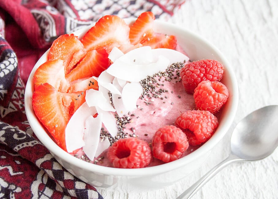 Berry Smoothie Bowl in bowl with spoon.