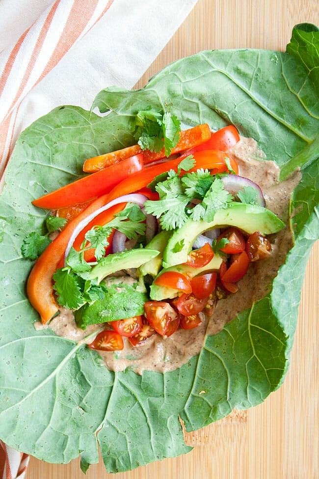 Collard Wrap open faced with spicy black bean hummus and veggies.