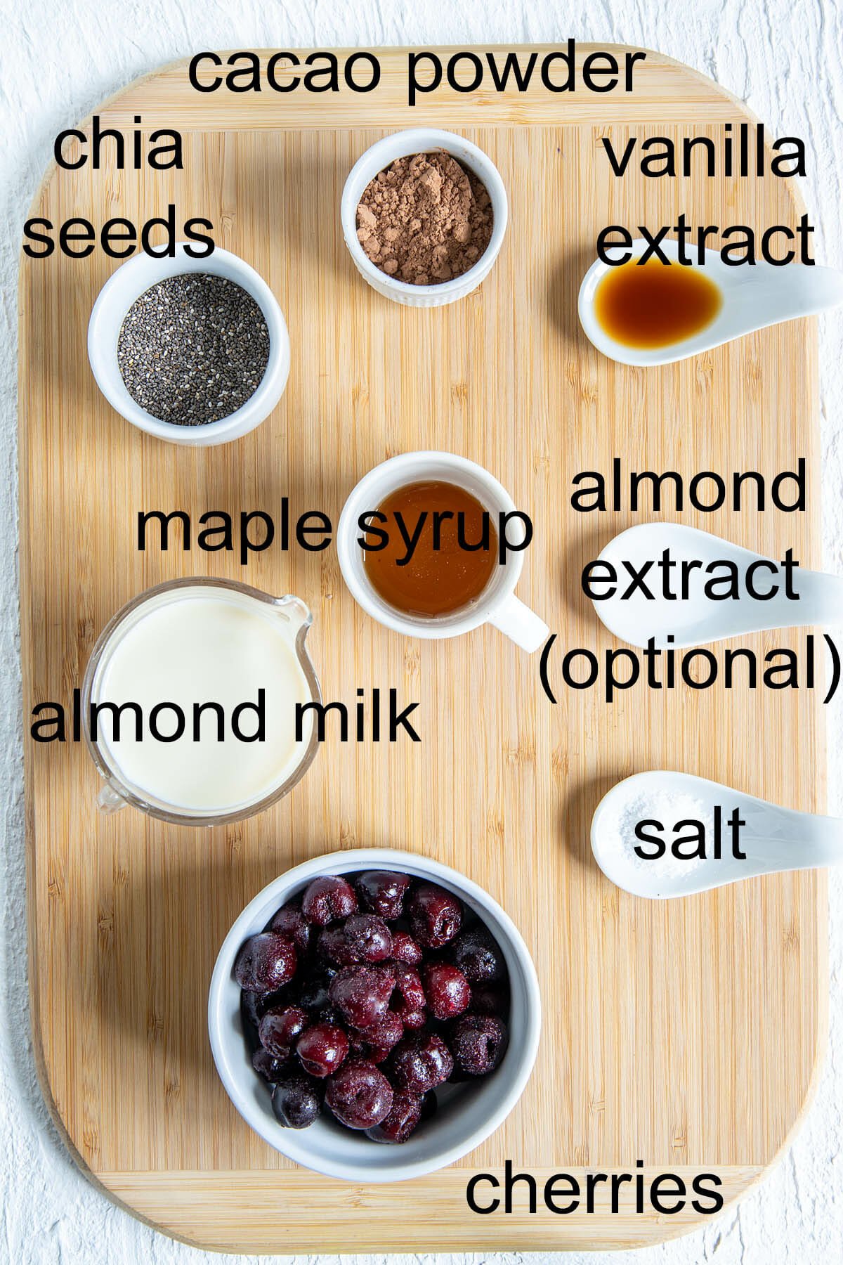 Ingredients for chocolate cherry chia pudding with labels.