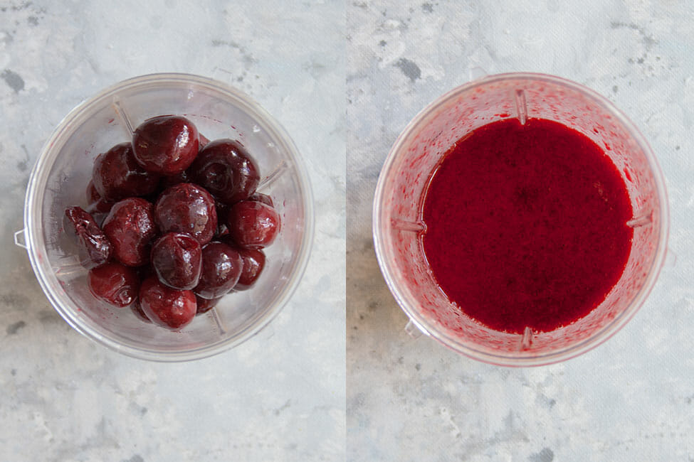 Frozen cherries being mixed in a Nutribullet with daiquiri ingredients.