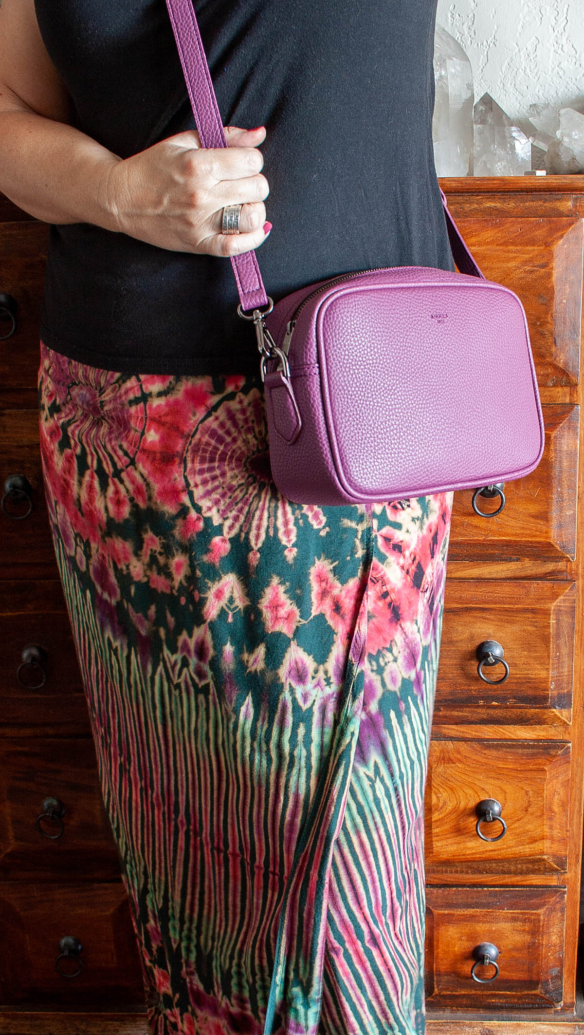 Me in black shirt, tie-dye skirt and purple Grace Mini Crossbody handbag over my shoulder.