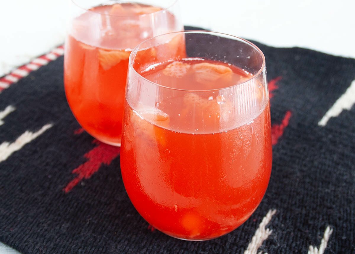 Strawberry Kombucha in wine glasses.