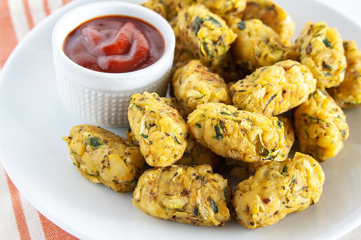 Zucchini Tots on plate with ketchup.