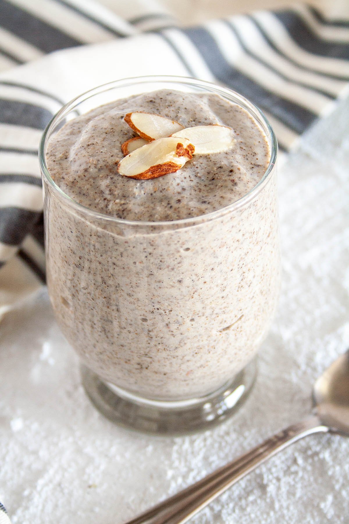 Almond Chia Pudding in jar with spoon.
