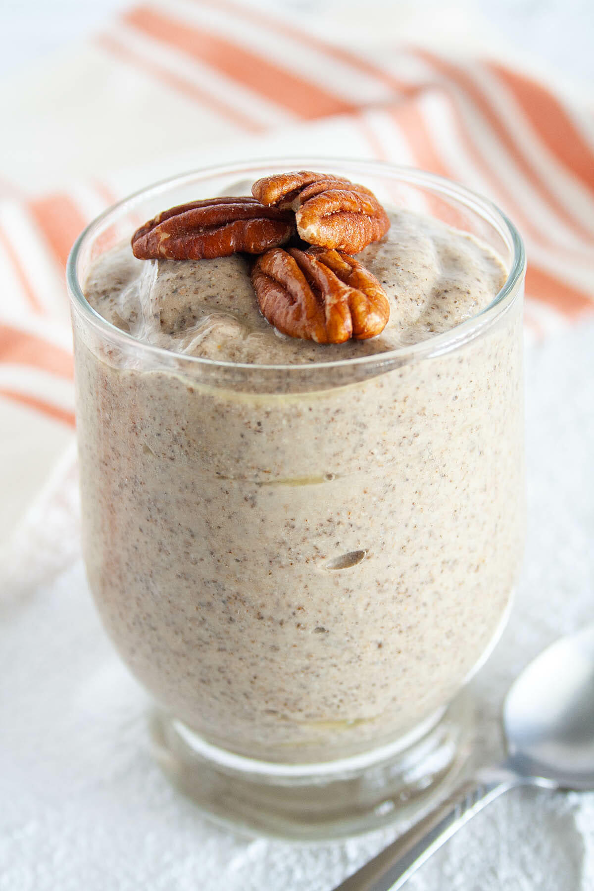 Pumpkin Chia Pudding inn jar with pecans on top.