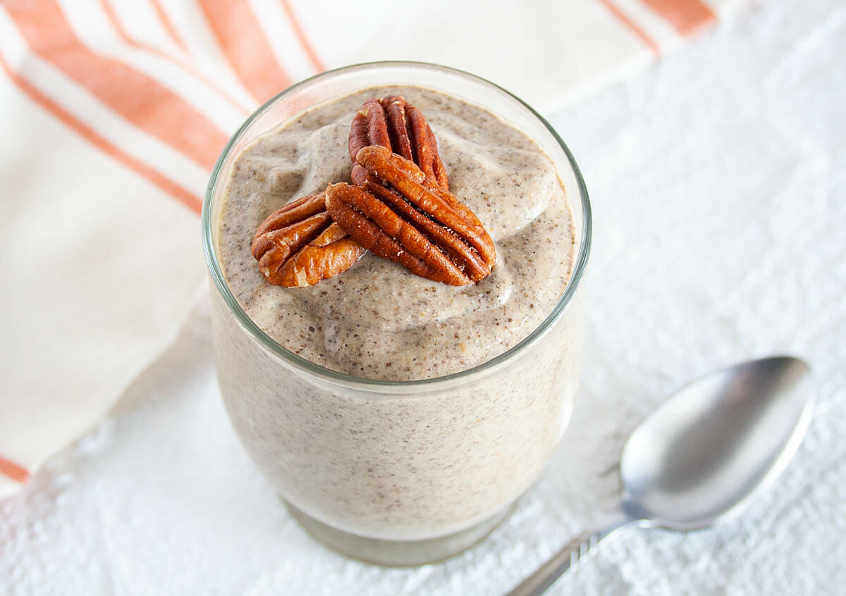 Pumpkin Chia Pudding in jar with spoon.