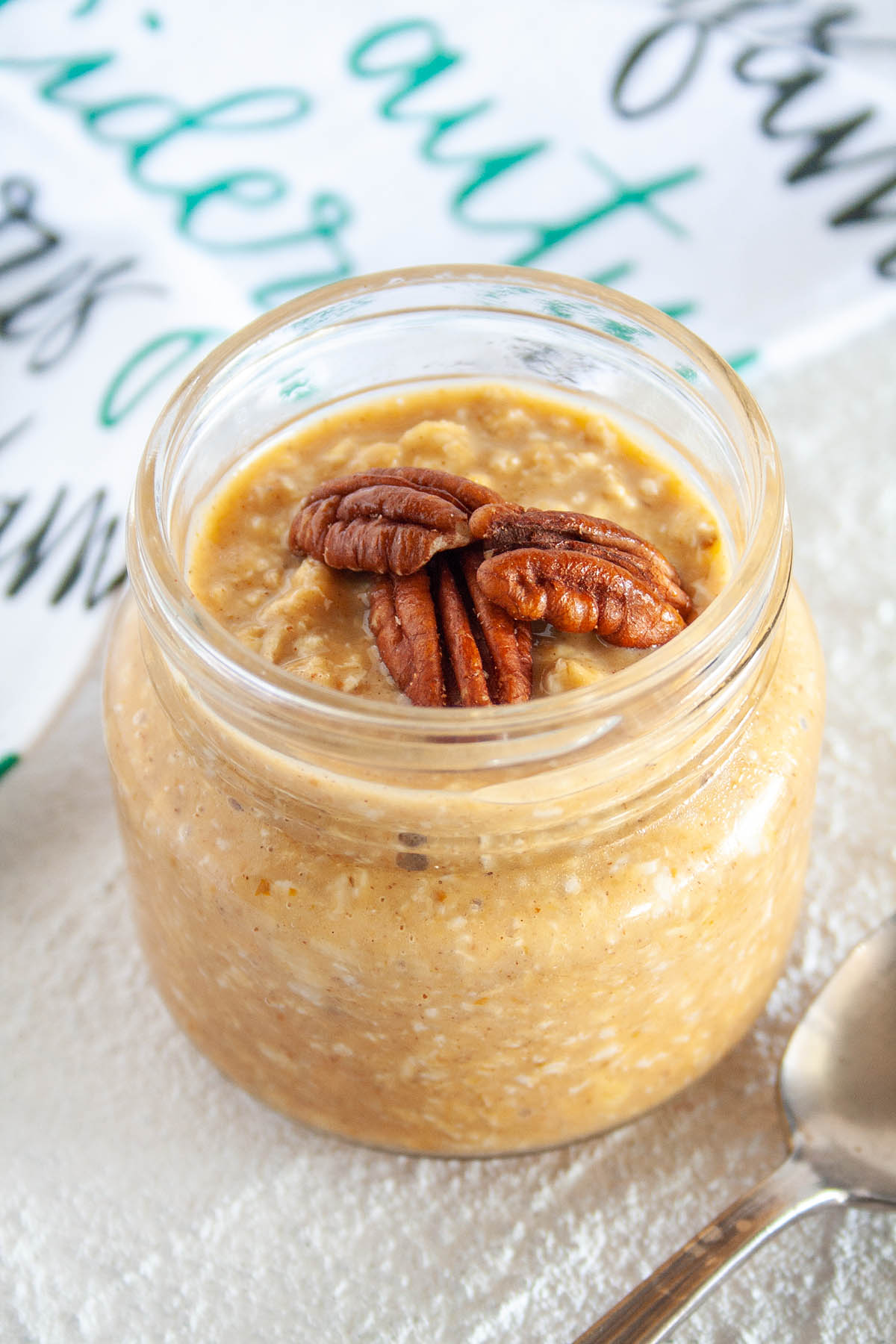 Pumpkin Pie Overnight Oats in a mason jar with spoon.