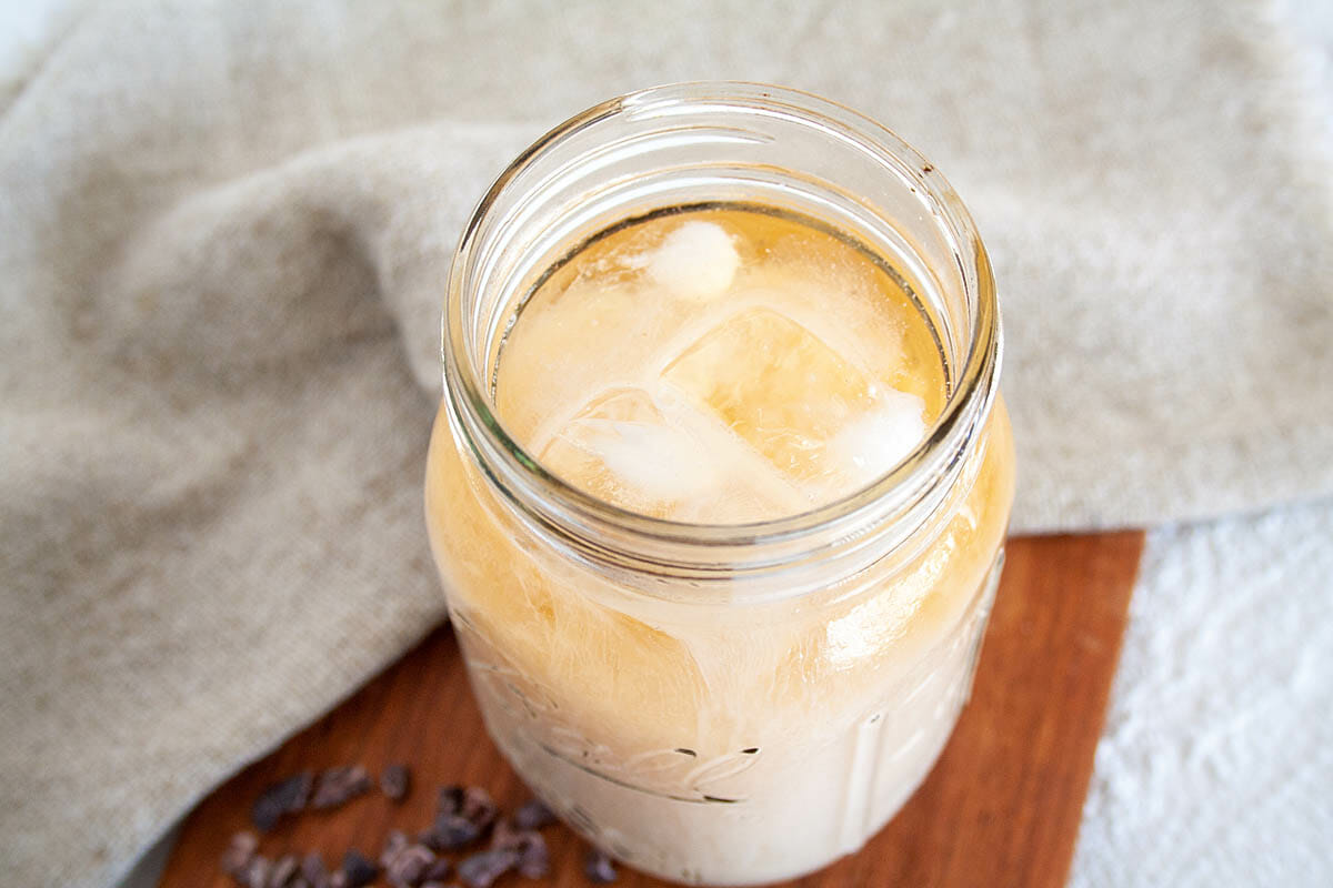 Cold Brew Cacao in mason jar with almond milk.