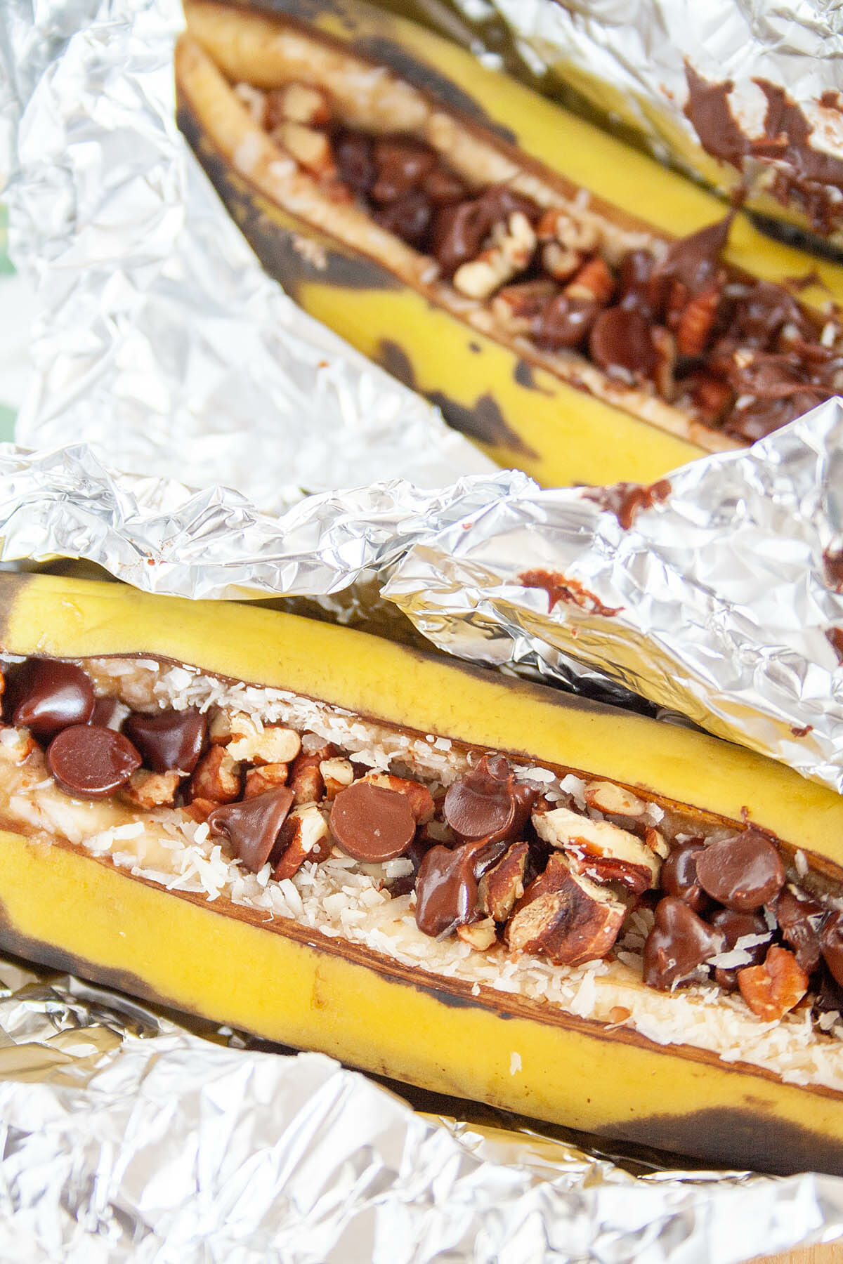 Two Campfire Stuffed Bananas in tinfoil close up.