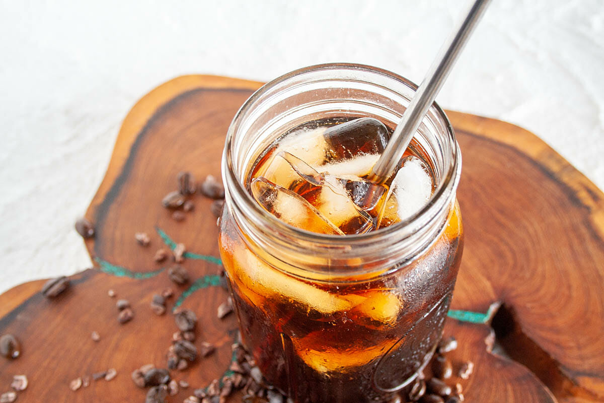 Cold Brew Cacao Coffee in mason jar on cutting board.