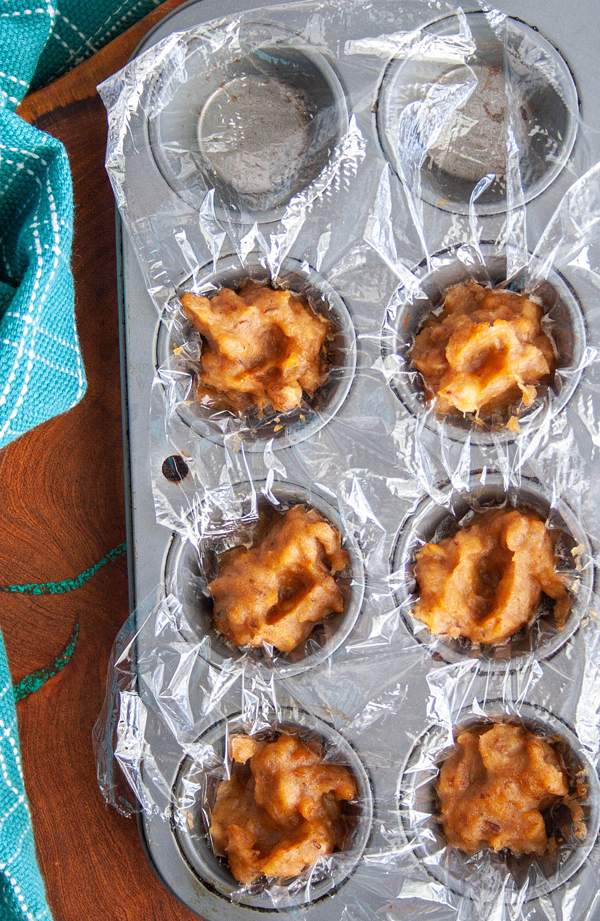 Frozen Date Paste in a plastic wrapped mini muffin pan.