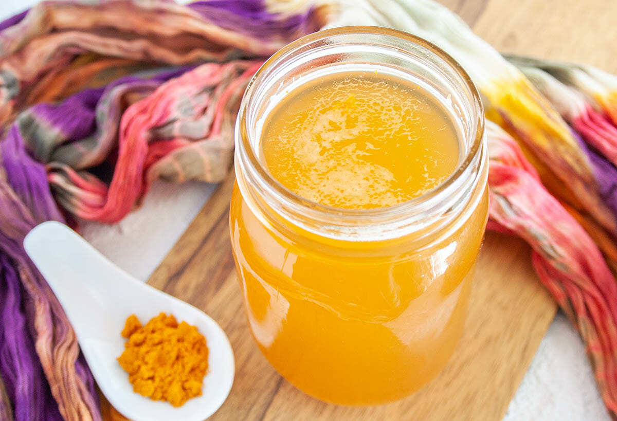 Lemon Turmeric Kombucha with spoonful of turmeric.