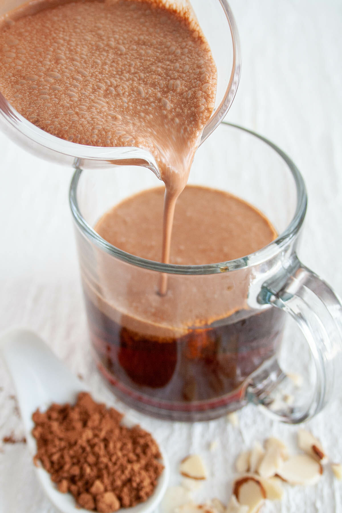 Chocolate Almond Creamer being poured into coffee.