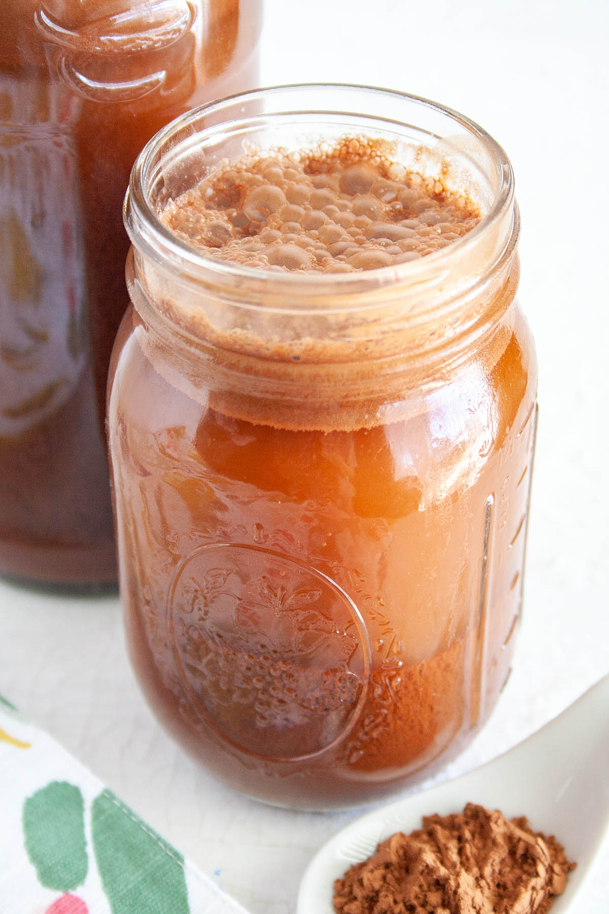 Chocolate Kombucha in a mason jar and bottle. 