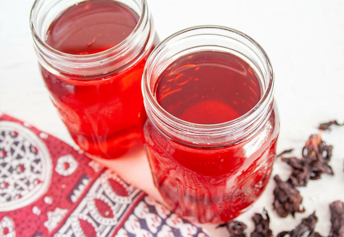 Hibiscus Kombucha in two mason jars.