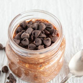 Chocolate Overnight Oats Without Chia Seeds in a mason jar with spoon.