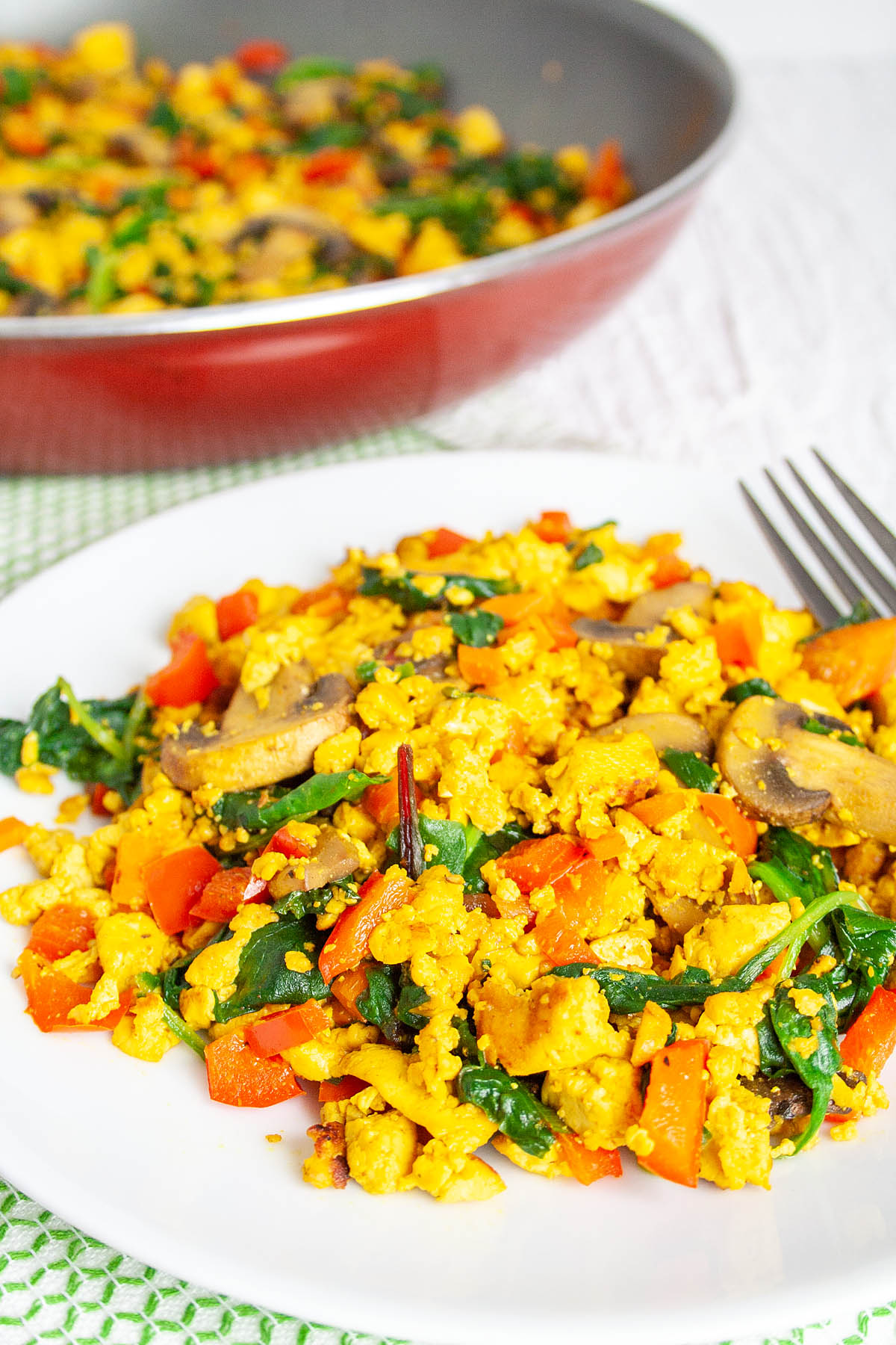 Tofu Scramble on plate with pan in the background.