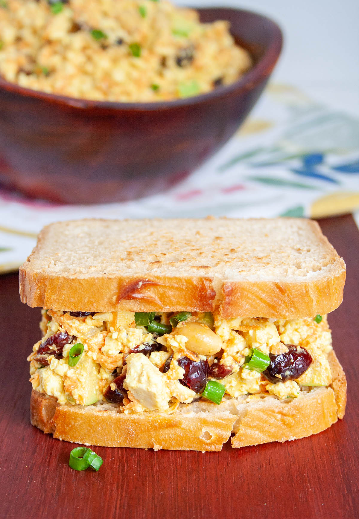 Curried Tofu Salad sandwich with a bowlful in the background.