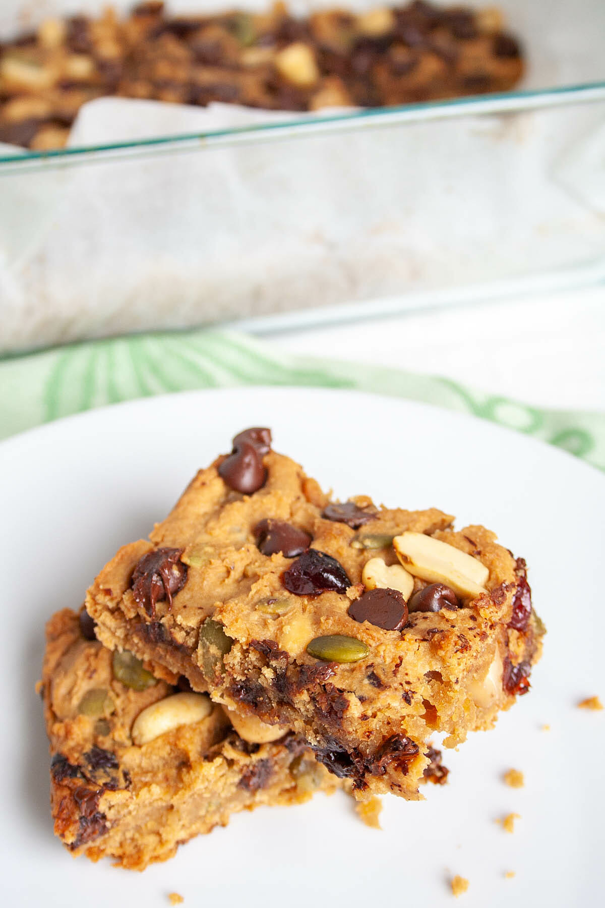 Trail Mix Blondies on a plate and in baking dish in the background.