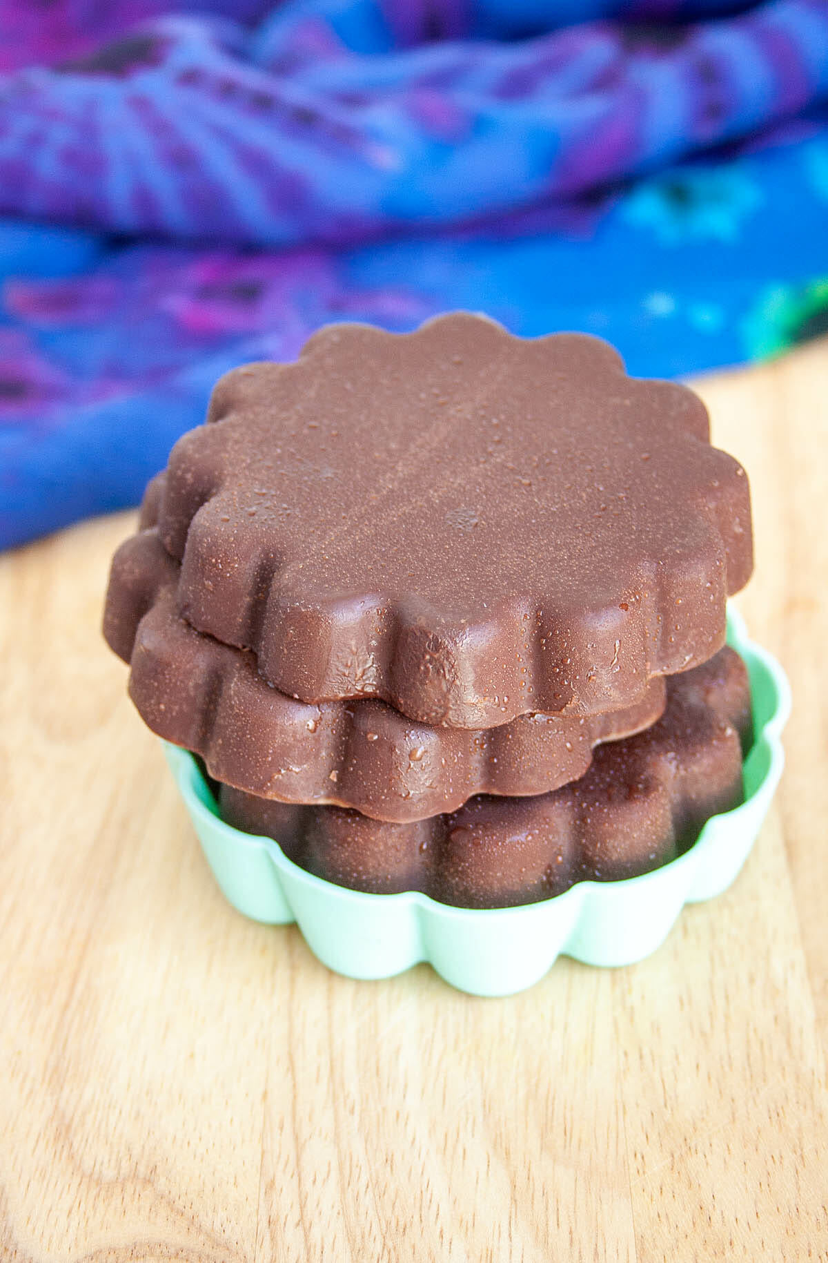 Vegan Chocolate discs stacked in silicone mold.