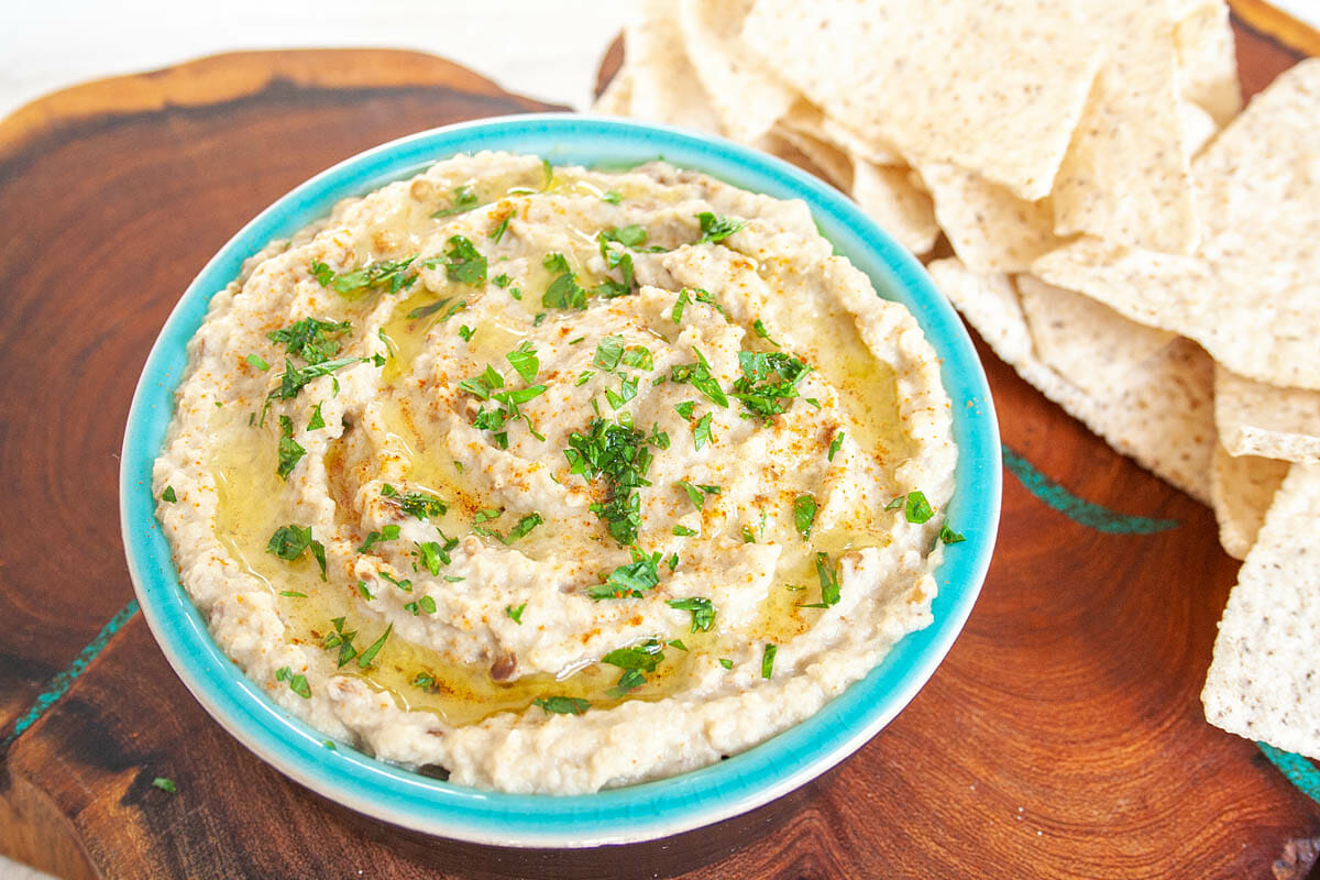 Baba Ghanoush in ramekin with tortilla chips.