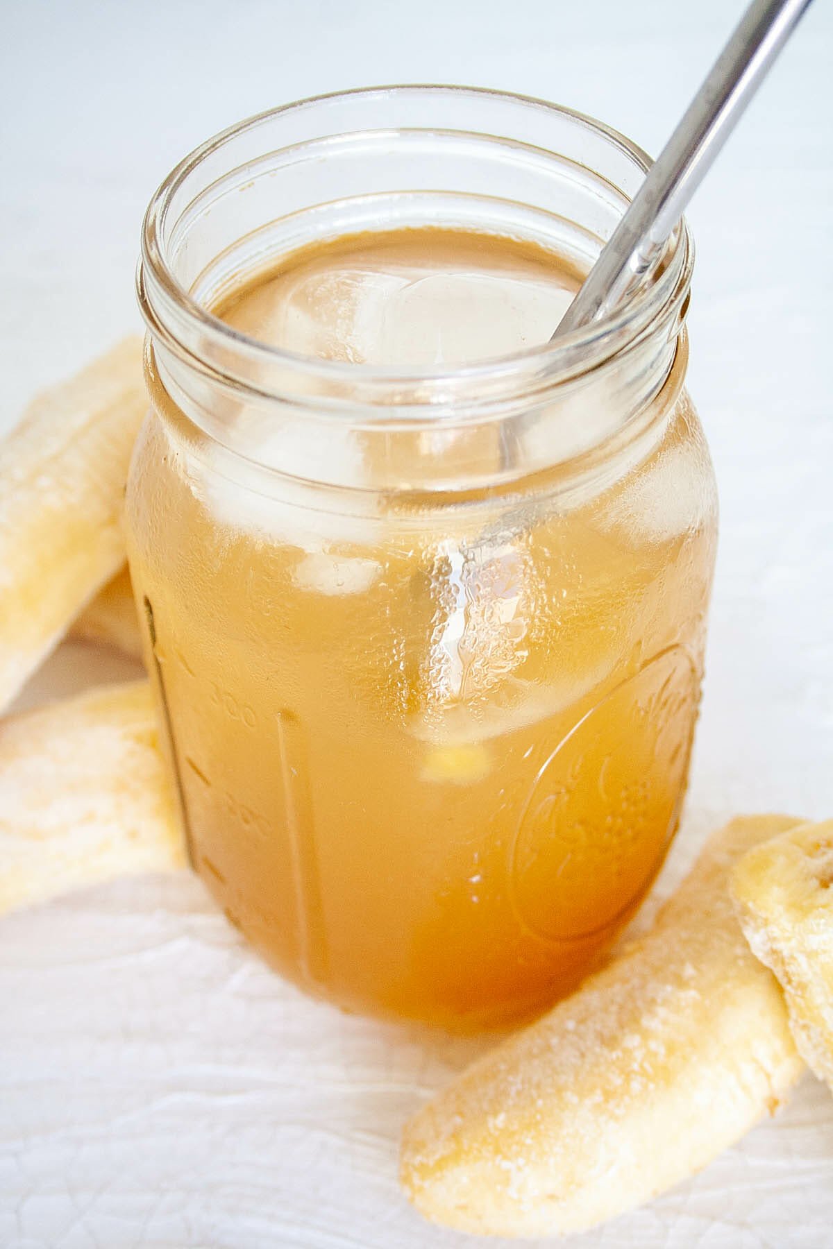 Banana Kombucha in mason jar with straw.