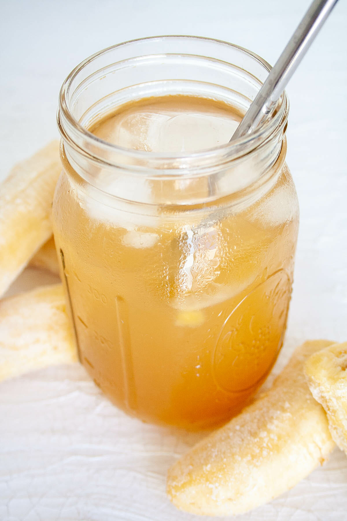 Banana Kombucha in mason jar with straw.