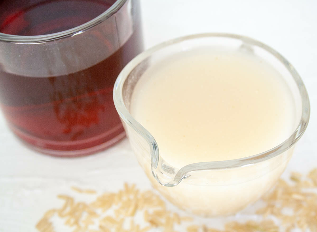 Rice Milk in a pitcher next to a mug of tea.