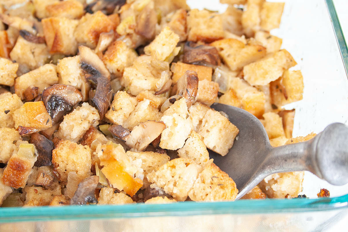 Spoonful of Vegan Stuffing in baking dish.