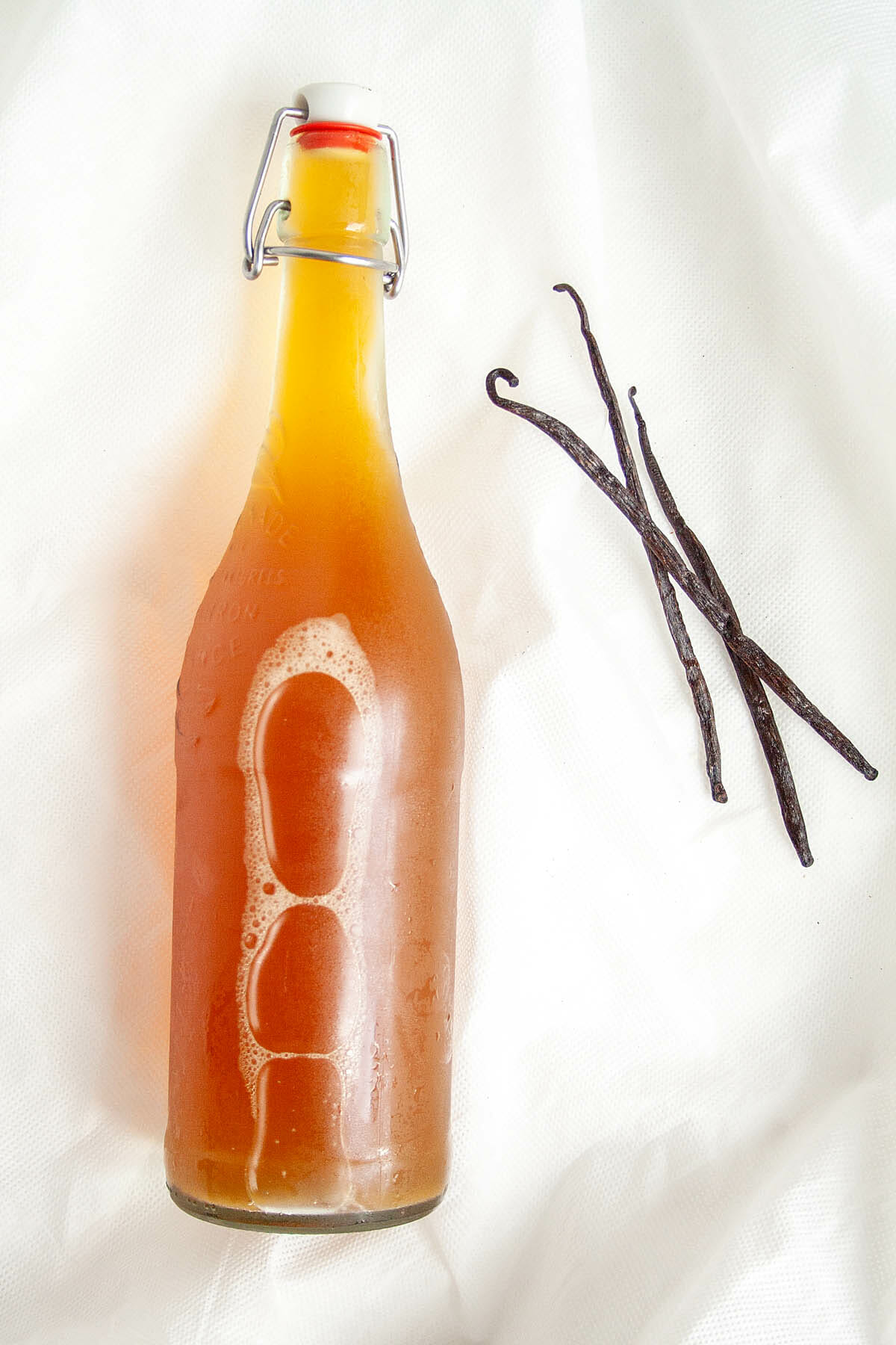 Vanilla Kombucha in bottle with vanilla bean.