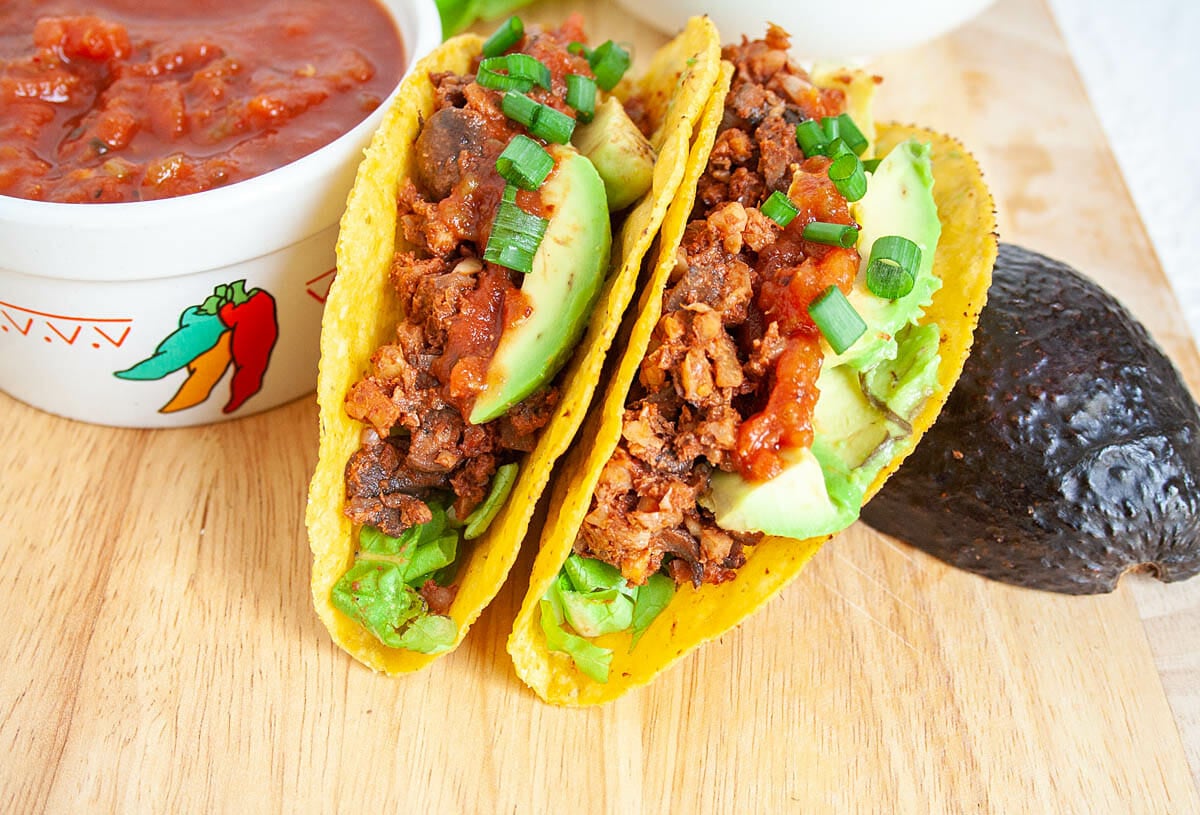 Walnut Taco Meat in tacos on cutting board with salsa.