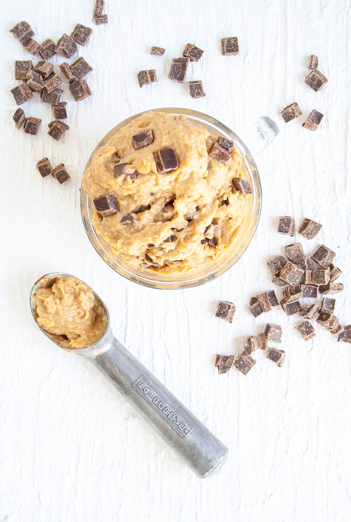 Chickpea Cookie Dough with dark chocolate chunks and ice cream scoop.