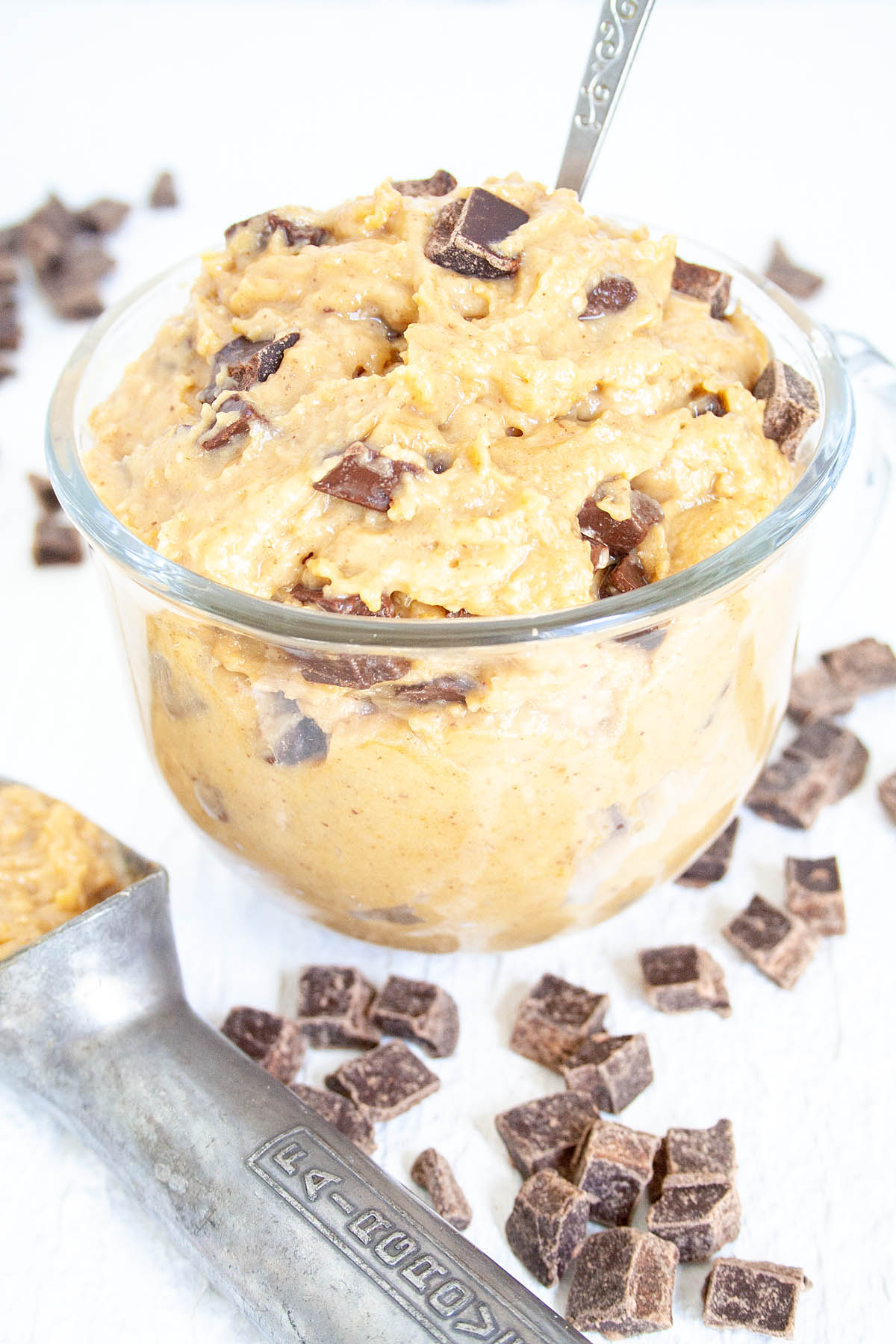 Chickpea Cookie Dough in a mug with ice cream scoop.