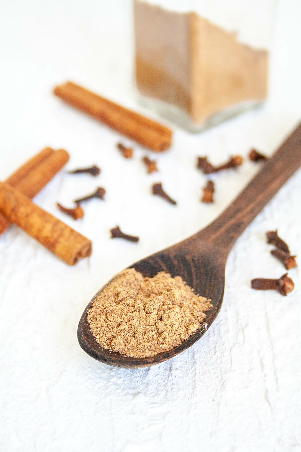 Spoonful of Chai Spice Mix with cinnamon sticks and cloves.