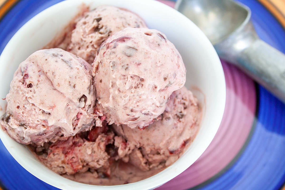 Cherry Chocolate Chip Ice Cream in bowl with ice cream scoop.