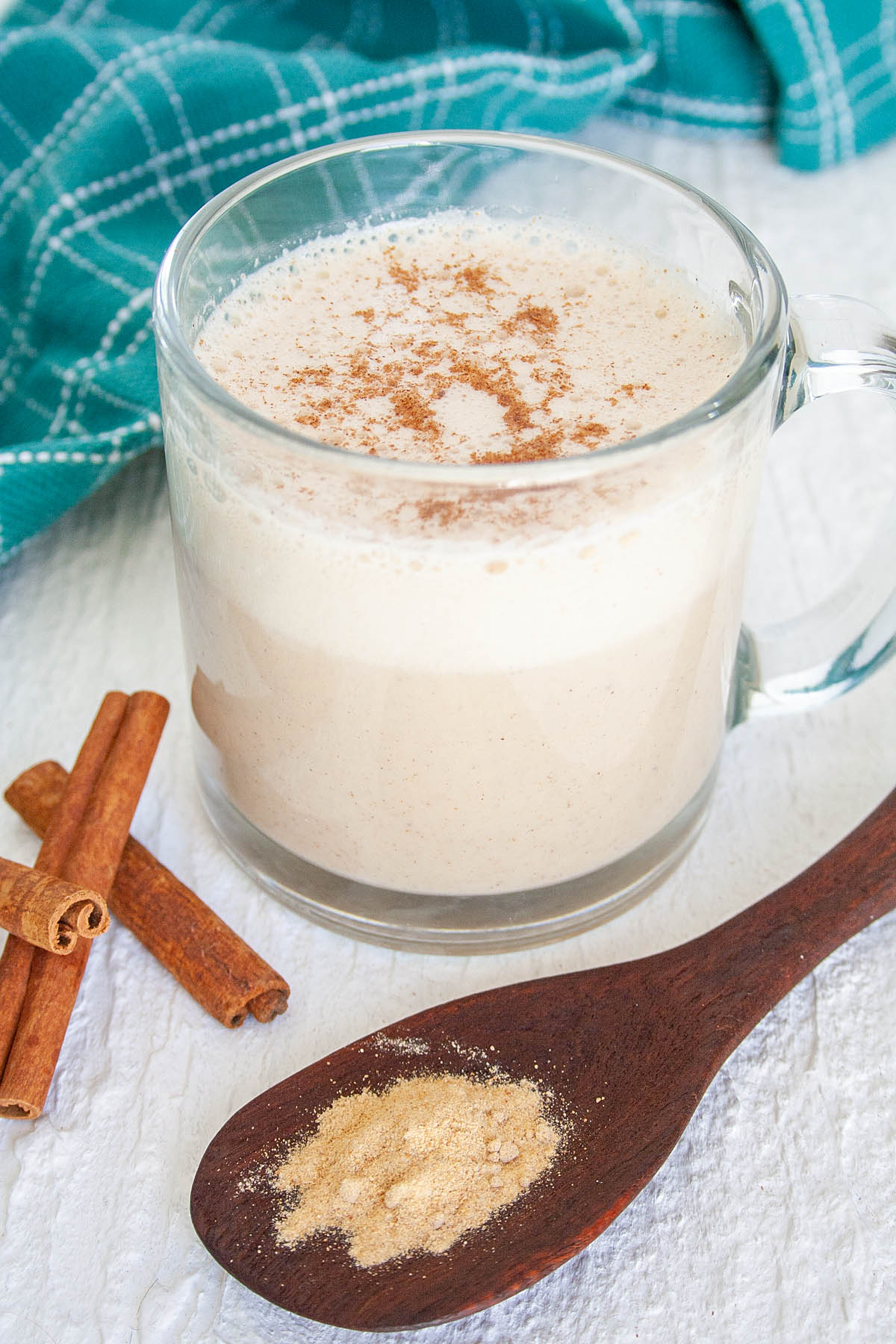 Maca Latte in a mug with spoonful of maca.