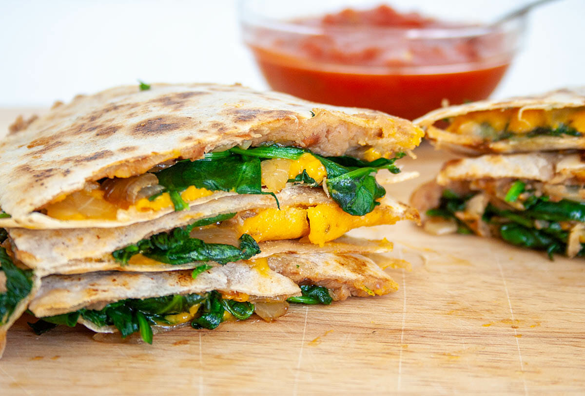 Spinach and Refried Bean Quesadilla on cutting board.