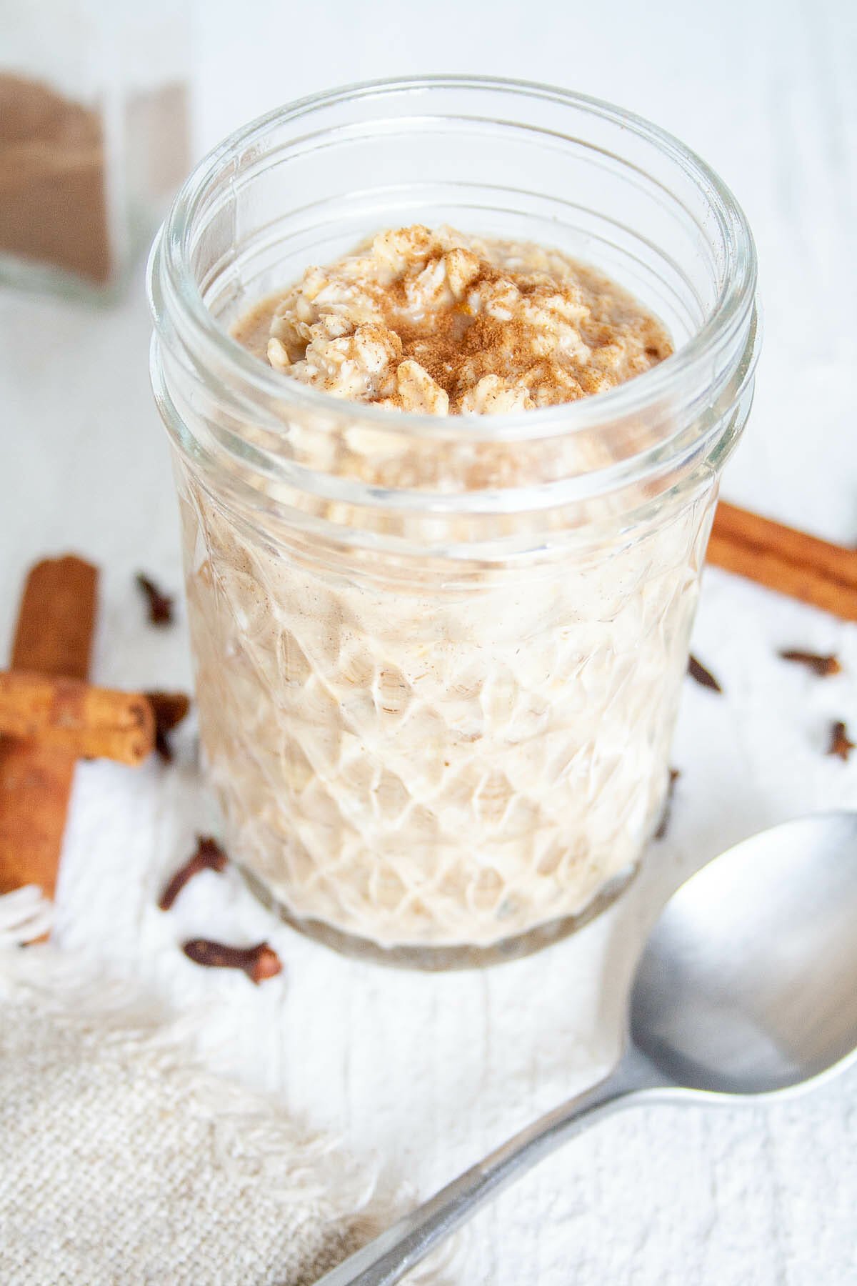 Chai Overnight Oats in mason jar with spoon.