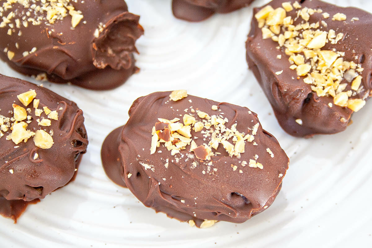 Chocolate Covered Peanut Butter Stuffed Dates on a plate.